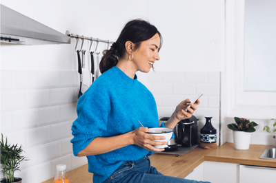 Customer scheduling laundry pickup from her kitchen
